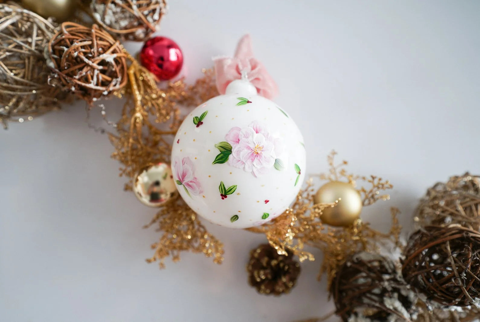 Hand painted florals and mistletoe on white glass ornament