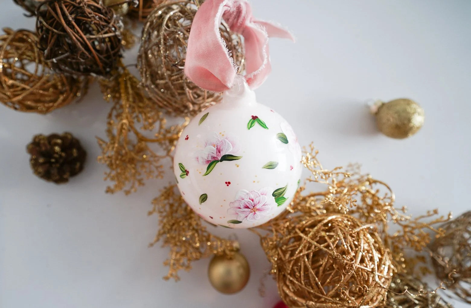 Hand painted florals and mistletoe on blush glass ornament