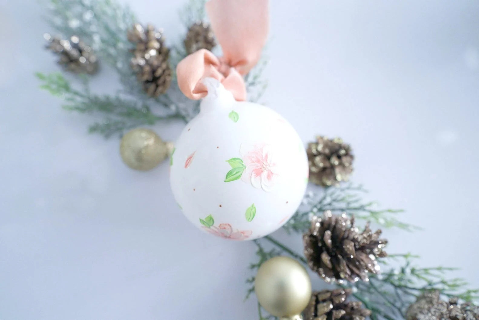 Hand painted peach and white florals on white glass ornament